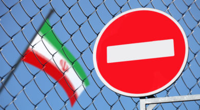 flag of Iran behind a fence with a sign is forbidden
