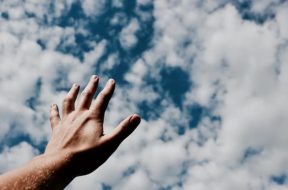 hands-fingers-arm-cloudy-blue-sky